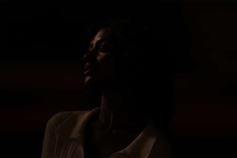 Retrato fotográfico de una mujer en una escena oscura a la luz de la luna